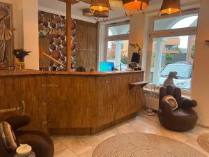 a bar in a room with chairs and a window at Pension Ottenheide in Schloß Holte-Stukenbrock