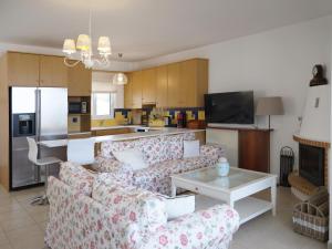 a living room with two couches and a kitchen at Orfeas Villa Porto Rafti in Porto Rafti