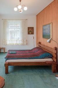 a bedroom with a large wooden bed in a room at Vila Jasna in Radovljica