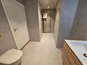 a bathroom with a toilet and a sink and a shower at Apartment with Balcony in Erling Skjalgssons in Oslo
