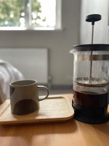 a cup of coffee sitting next to a blender at Spacious Double Room with Private Bathroom in Streatham Common, Southwest London in Streatham Vale