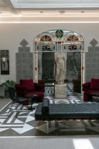a living room with a fireplace with a statue in it at Hotel Boutique Casa Romana Villa in Seville