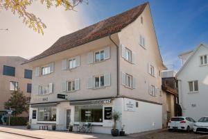 a large building with a roof on a street at Boho-Wohnflair mitten in Dornbirn - Bali 2 in Dornbirn