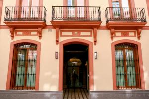 an entrance to a building with two balconies at Hotel Boutique Casa Romana Villa in Seville