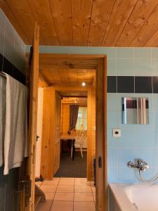 a bathroom with a sink and a room with a table at Edelweiss 4 Zi Ferienwohnung in Landhaus in Frutigen