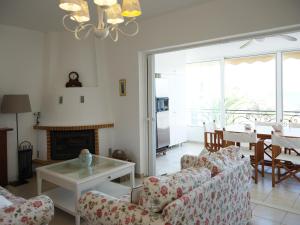 a living room with a couch and a table at Orfeas Villa Porto Rafti in Porto Rafti