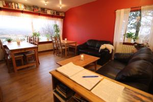 a living room with a couch and a table at CJA Guesthouse in Laugar