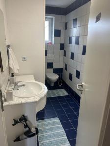 a bathroom with a sink and a toilet at Wohnung VS in Villingen-Schwenningen +5 photos
