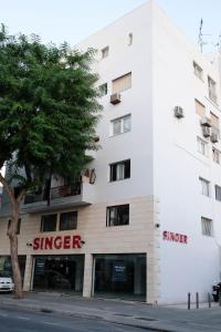 a white building with the word singer on it at Lima Residence in Nicosia