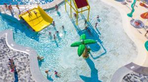 an overhead view of a swimming pool with people in it at Glamping Aglientu in Vignola Mare