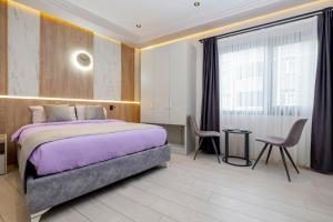 a bedroom with a large bed and a window at Lavender Airport Hotel in Arnavutköy