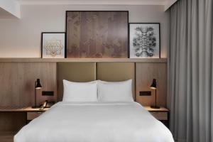 a bedroom with a large white bed and two lamps at Residence Inn by Marriott Vienna City East in Vienna
