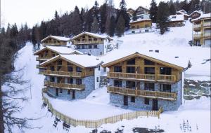 a group of buildings in the snow at Turracher Zirbenlodges in Turracher Hohe