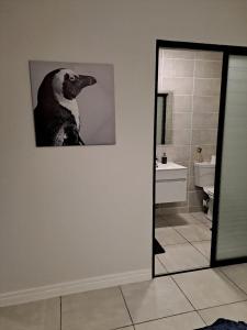 a picture of a dog on a wall in a bathroom at Joy Apartment@The Blyde in Pretoria