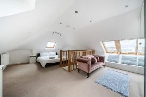 a bedroom with a bed and a chair in a room at Sandy Feet Retreat in South Hayling