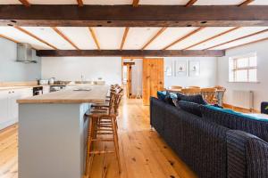 una cucina e un soggiorno con tavolo e sedie di Large converted barn in peaceful, rural location a Hambleton