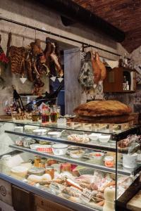 a display case in a bakery with lots of food at Little Zrin Rooms in Zagreb