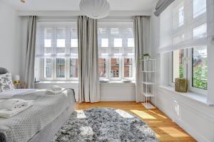 a bedroom with a bed and a large window at Lion Apartments -TOKIO Premium Apartment at the Sopot Center in Sopot