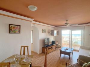 a living room with a couch and a table and a television at Spanish Connection - Los Miradores del Puerto in La Manga del Mar Menor