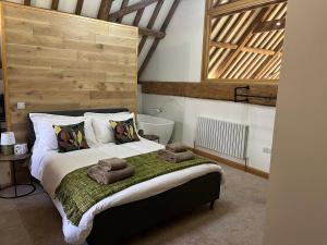 a bedroom with a bed with towels on it at Grange Farm Barn, Filby in Filby