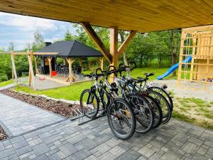 a group of bikes parked under a pavilion with a playground at Beskidzki Zakątek Krynica-Zdrój in Krynica Zdrój
