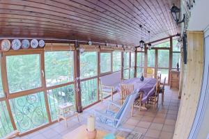 a dining room with a table and chairs and windows at Casa el Cerezo Rojo in El Rasillo