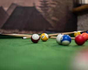 a group of billiard balls and cues on a pool table at Willa Dream z basenem i jacuzzi in Poronin