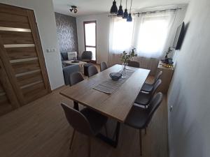 a dining room with a wooden table and chairs at Apartmán Vendelínka in Valtice