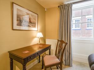 a room with a desk and a chair and a window at Malabar House in Lyme Regis