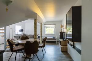 a kitchen and dining room with a table and chairs at Voyage Hotel in Leipzig