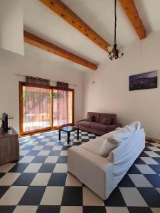 a living room with a couch and a checkered floor at Votre Évasion Provençale : Villa de Prestige à Marseille in Marseille