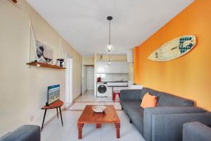 a living room with a couch and a table at NEW! IDEAL FLAT FOR GROUPS TO WORK or SURF in Corralejo