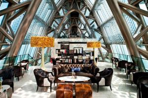 a lobby with chairs and tables in a building at The St. Regis Shenzhen in Shenzhen