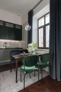 a kitchen and dining room with a table and chairs at Вишукані апартаменти у історичному маєтку в парку in Kyiv