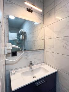 a bathroom with a sink and a mirror at Galata Inn Hotel in Istanbul