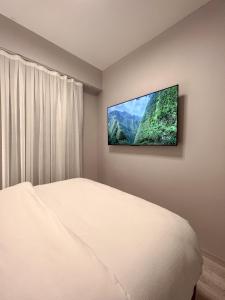 a bedroom with a flat screen tv on the wall at Galata Inn Hotel in Istanbul