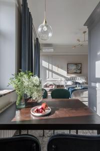 a dining room with a table with a plate of food on it at Вишукані апартаменти у історичному маєтку в парку in Kyiv