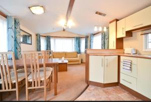 a kitchen and living room with a table and chairs at KINSGATE 2 in Shanklin