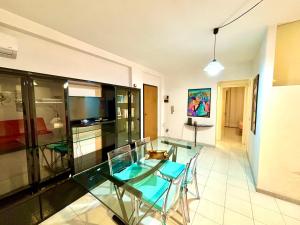 a glass table and chairs in a room at Long Life Quartu Poetto in Quartu SantʼElena