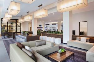 a living room with couches and a bar at Element Boston Seaport District in Boston