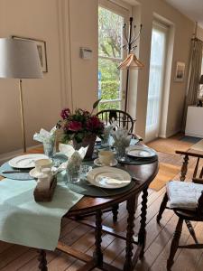 a dining room table with plates and flowers on it at TimeOut-Breda in Breda
