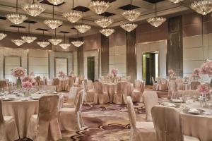 a ballroom with tables and chairs and chandeliers at The Ritz-Carlton Beijing, Financial Street in Beijing +53 photos