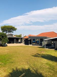 a group of houses with a grass yard at Mino Guest House in Pietermaritzburg