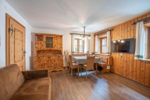 a living room with a table and a dining room at Ferienhaus zur Hackenschmiede in Mauterndorf