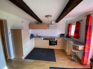 a kitchen with white cabinets and a stove top oven at Zillertaler Sennhuette in Hart im Zillertal