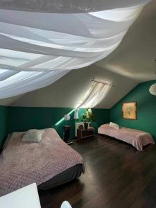 a bedroom with two beds and a white ceiling at Dom całoroczny na wynajem - Zalesie nad jeziorem Chełmżyńskim koło Torunia 