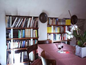 a dining room with a table and book shelves filled with books at B&B Contrada Lunga in Abbadia Lariana
