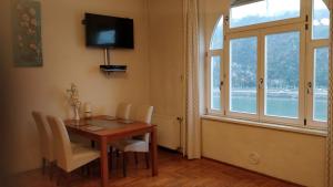 a dining room with a table and chairs and a window at Danube View in Budapest