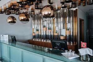 a barber shop with chandeliers hanging from the ceiling at Hotel Praia Marina by RIDAN Hotels in Praia da Vitória