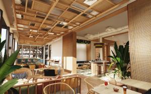a restaurant with wooden ceilings and tables and chairs at Ocean Drive Sevilla in Seville